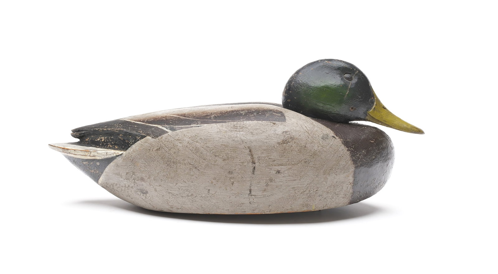 Enoch Reindahl (1904-2000), Tustin, Wisconsin.: Lowhead mallard. Hollow carved with relief crossed wingtips. Measures 15.5" long. Provenance: Dr. Michael Shannahan collection.