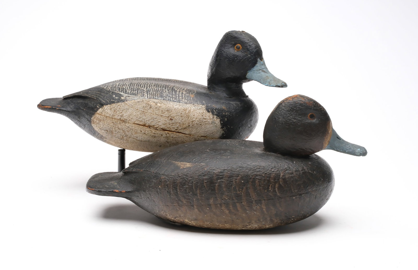 Enoch Reindahl (1904-2000), Tustin, Wisconsin.: Rigmate pair of bluebills. Hollow carved with relief wingtip carving. Drake with slightly turned head. Maker's name painted on underside. Measure 12.25" long. Provenance: Dr. Michael Shannahan collect