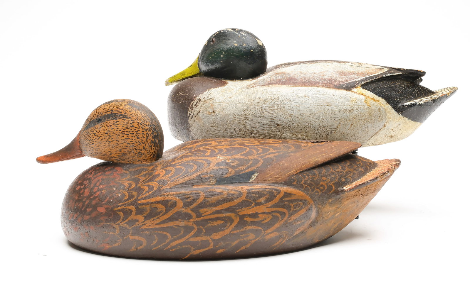 Russel "Raz" Barry, Stoughton, Wisconsin.: Pair of lowhead mallards. Relief carved wingtips and side pockets. Carved sleepy eyes on hen. Measure 15" and 15.5" long. Provenance: Dr. Michael Shannahan collection.