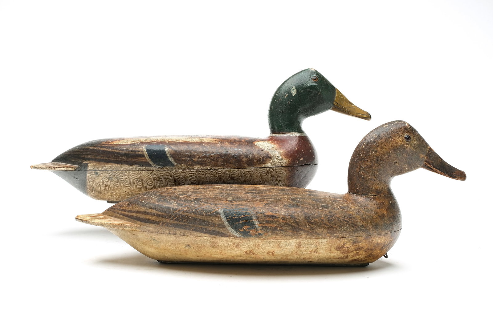 Robert Elliston (1849-1915), Bureau, Illinois.: *PAIR* Pair of mallards. Hollow carved with comb feather paint detail on drake. Scratch feather paint detail on hen. Both retain the original Elliston weight. Measure 17.25" long.