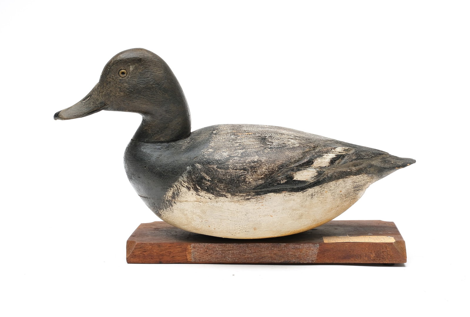 Ben Schmidt (1884-1968), Detroit, Michigan.: Rare hollow carved bluebill. Full round body with relief wing carving and slightly turned head. Never rigged or weighted. Decoy was mounted to a presentation plaque. Measures 13.75" long.