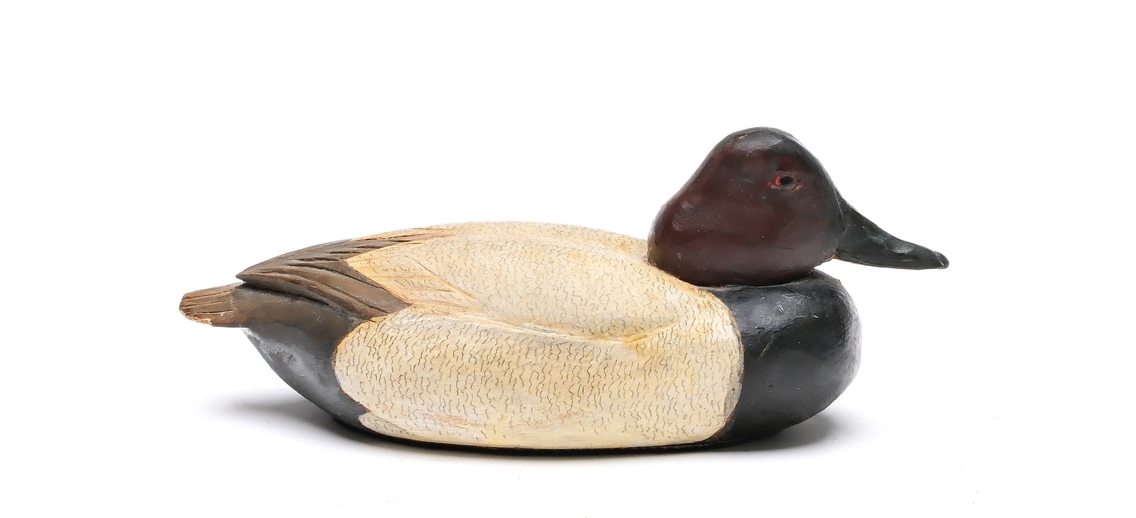 Tom Schroeder (1886-1976), Detroit, Michigan.: 1/4 size canvasback. Tucked head with sleepy eye carving and relief wingtips. Measures 7" long.