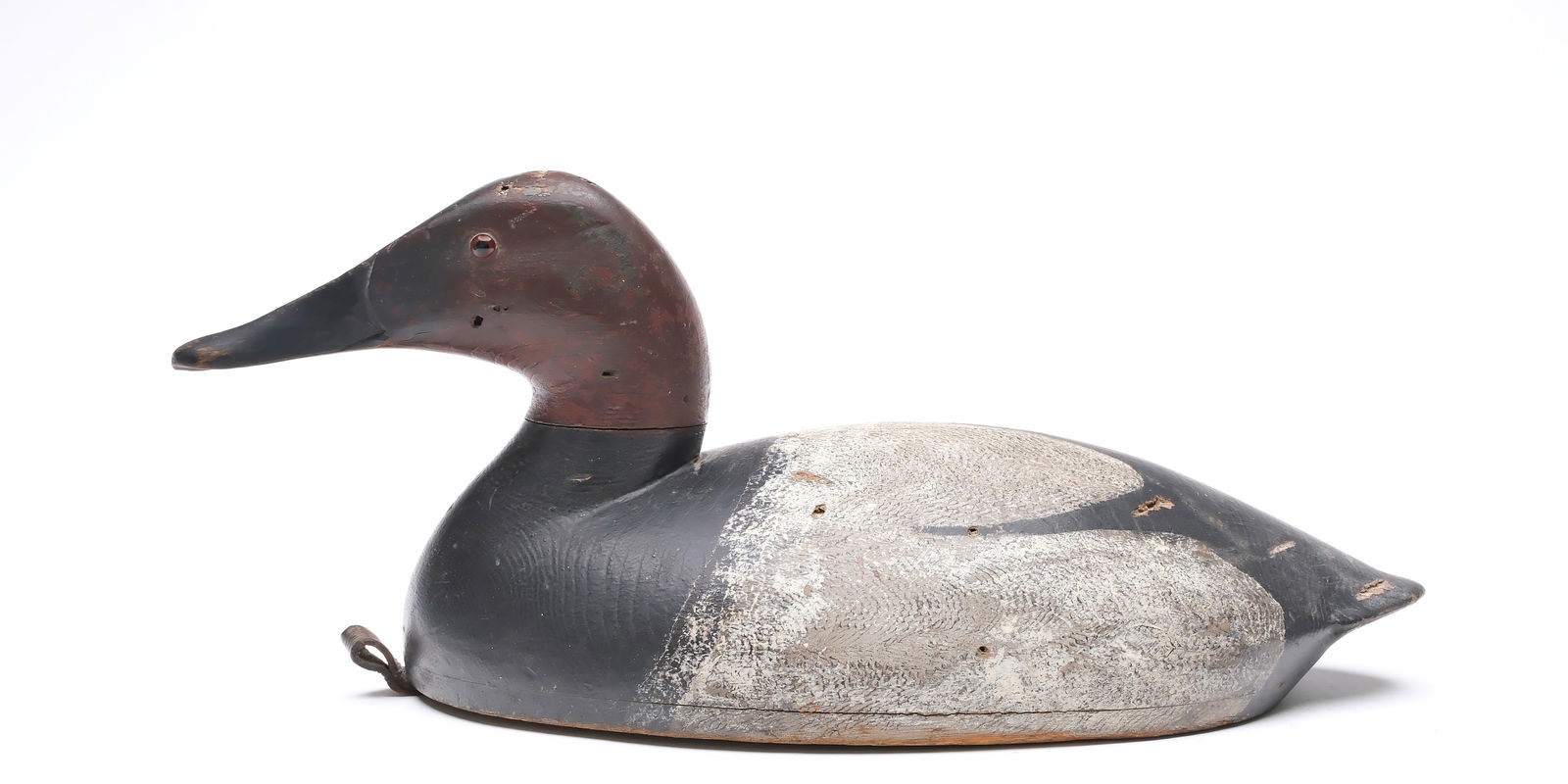 John R. Wells (1861-1953), Toronto, Ontario.: Canvasback. Hollow carved with .25" bottom board. Branded "JRW Maker." Measures 16.25" long. Provenance: Deborah and Martin Maloy collection.