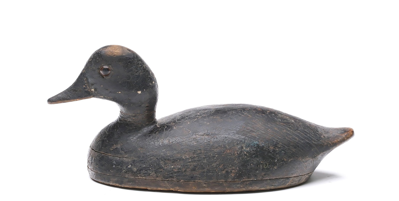 Tiny bufflehead hen from Ontario, circa 1900.: Hollow carved with raised neck seat. Similar to the work of John R. Wells. "D Maddocks" carved in underside. Measures 9.75" long. 