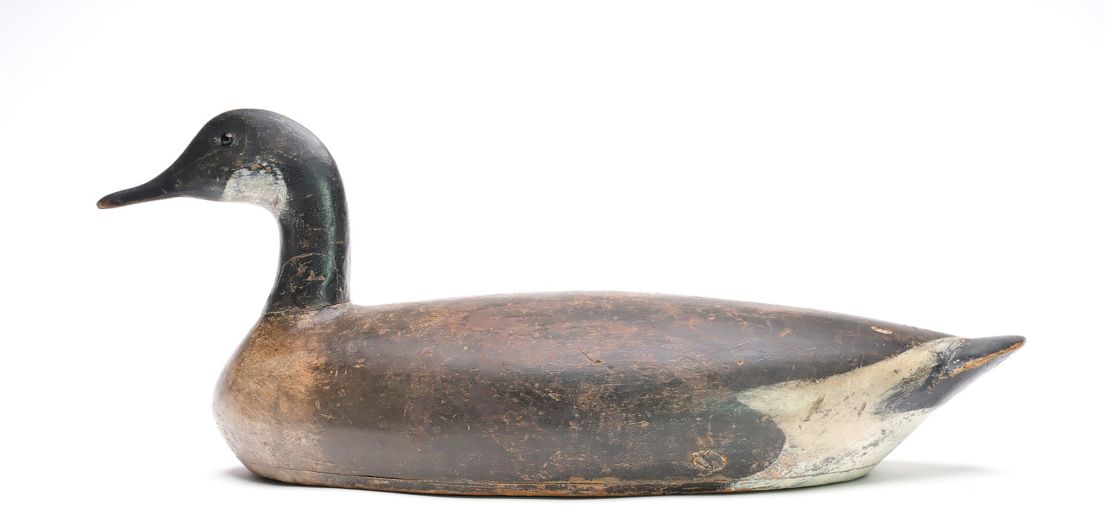Early Canada goose from Toronto, Ontario.: Long hollow body with slight relief wingtip carving. Measures 25" long. Provenance: Dean Hyde collection.