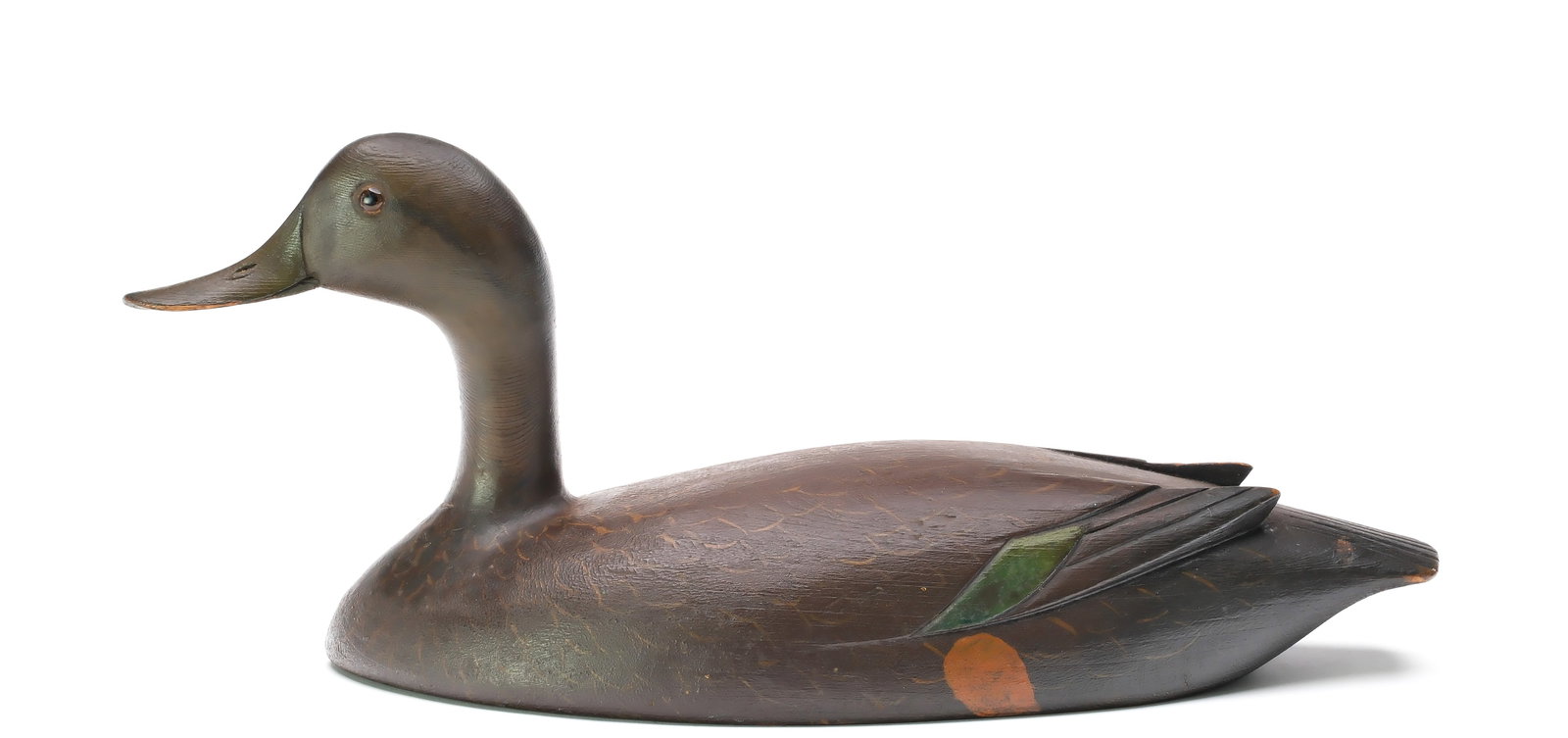 David W. Nichol (1890-1977), Smith Falls, Ontario.: High head black duck. Solid body with relief wingtip carving. Measures 17.5" long. Provenance: Dean Hyde collection