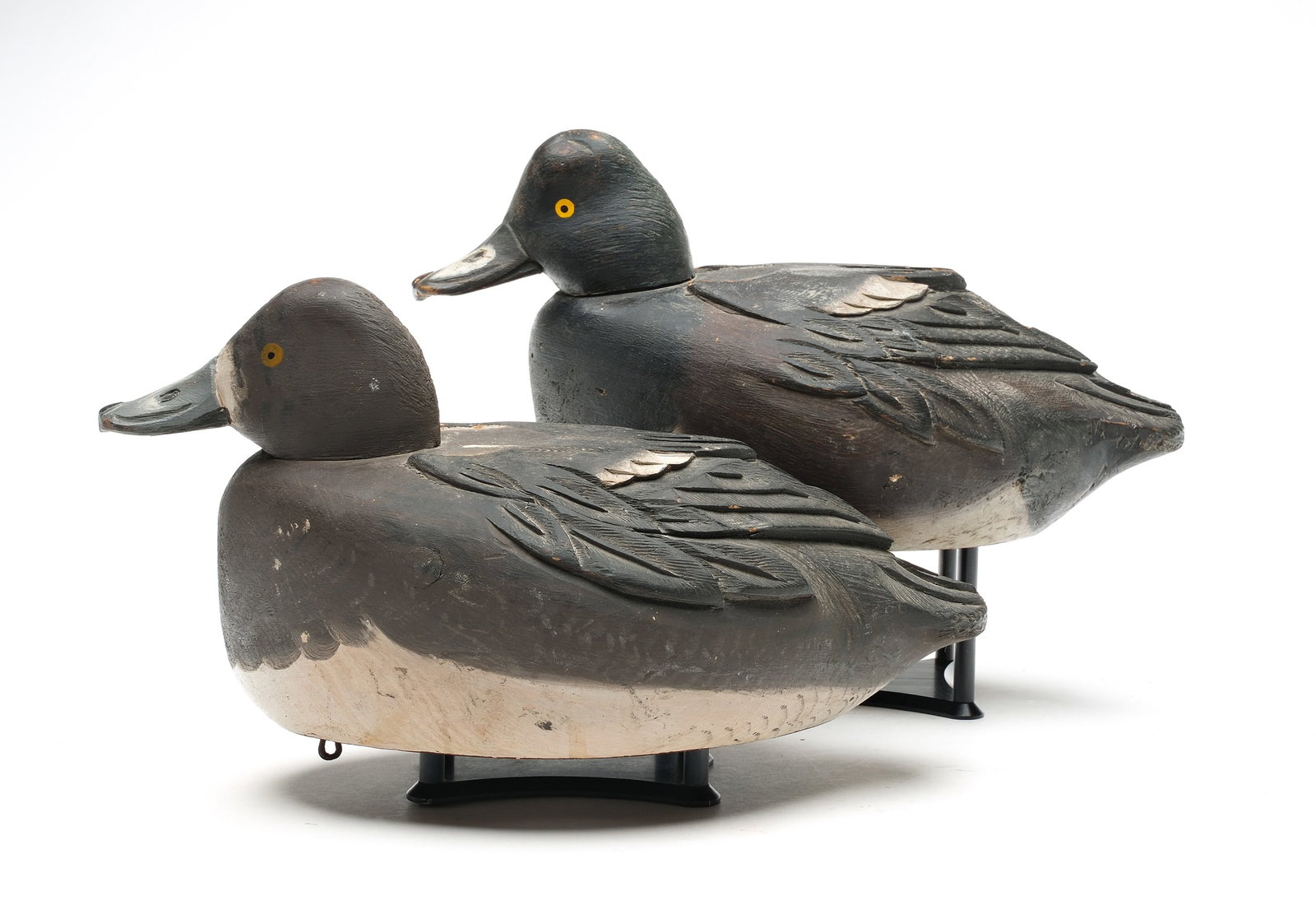 Orel Leboeuf, (1886-1968), St. Anicet, Quebec.: Pair** of bluebills. Tucked heads and deep relief feather carving. Measure 14" long. Provenance: Bill and Alice Walsh Collection. Obtained from Oliver Auction, July 5&6, 1986.