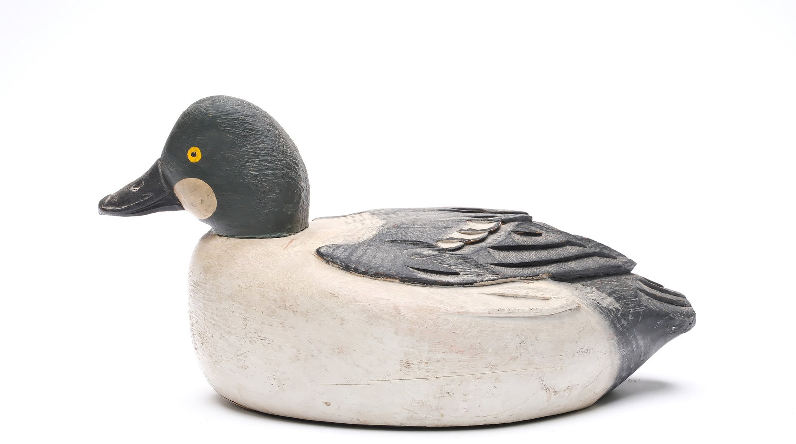 Orel Leboeuf, (1886-1968), St. Anicet, Quebec.: **SINGLE OR PAIR** Goldeneye with slightly turned head and deep relief feather carving. Measures 14" long. Provenance: Bill and Alice Walsh Collection. Obtained from George Thompson at July, 1982