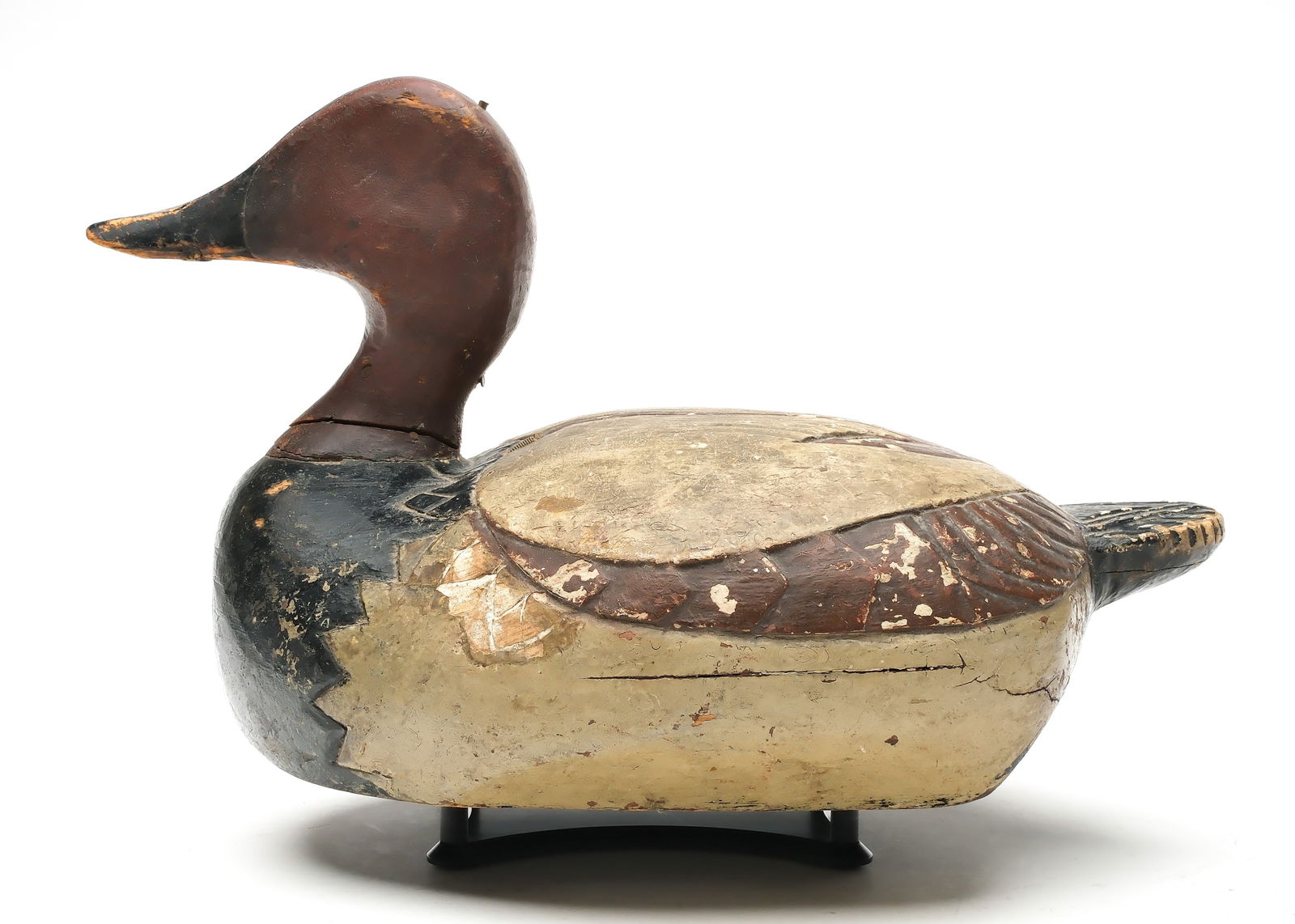 Frank Buchner (1871-1947), Erie, Pennsylvania.: Canvasback. Wide body with relief wing carving, including heart and anchor. Reared back head. Measures 15" long.