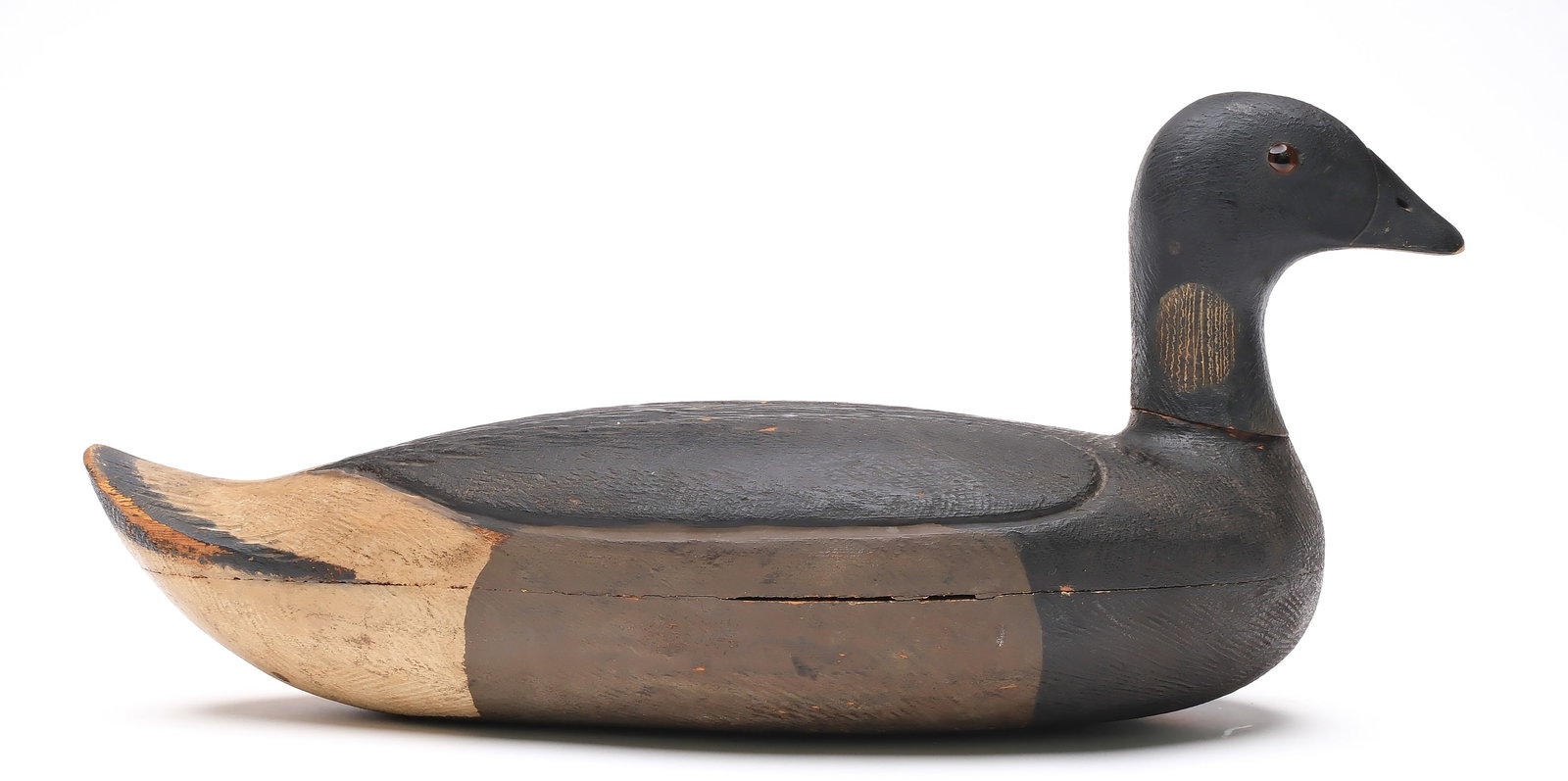 Chauncey Wheeler (1888-1937), Alexandria Bay, New York.: Brant. Hollow carved with relief carved "torn heart" pattern on back. Upswept tail with incised feather carving. "W.F.B." branded on underside. Measures 18.5" long. Provenance: Dean Hyde collection.