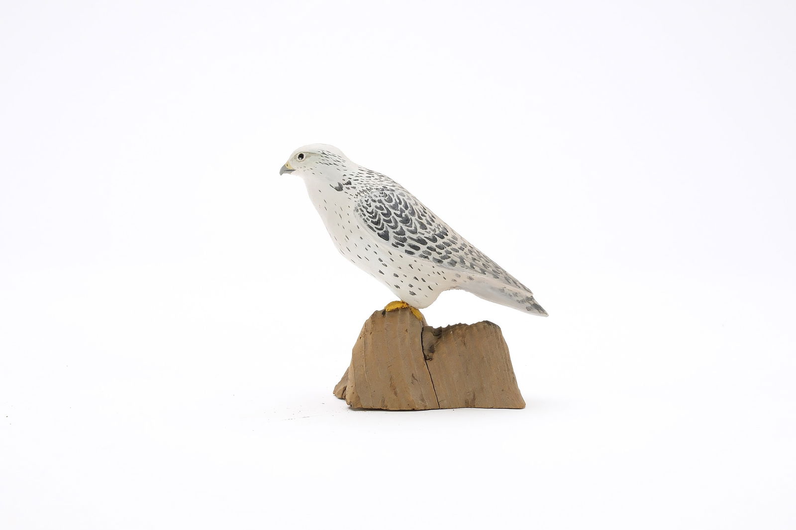 Harold Gibbs (1886-1970), Barrington, Rhode Island.: Miniature white gyrfalcon. Relief wing carving. Initialed and identified on underside. Measures 3.25" long. Provenance: Joseph Ellis collection.