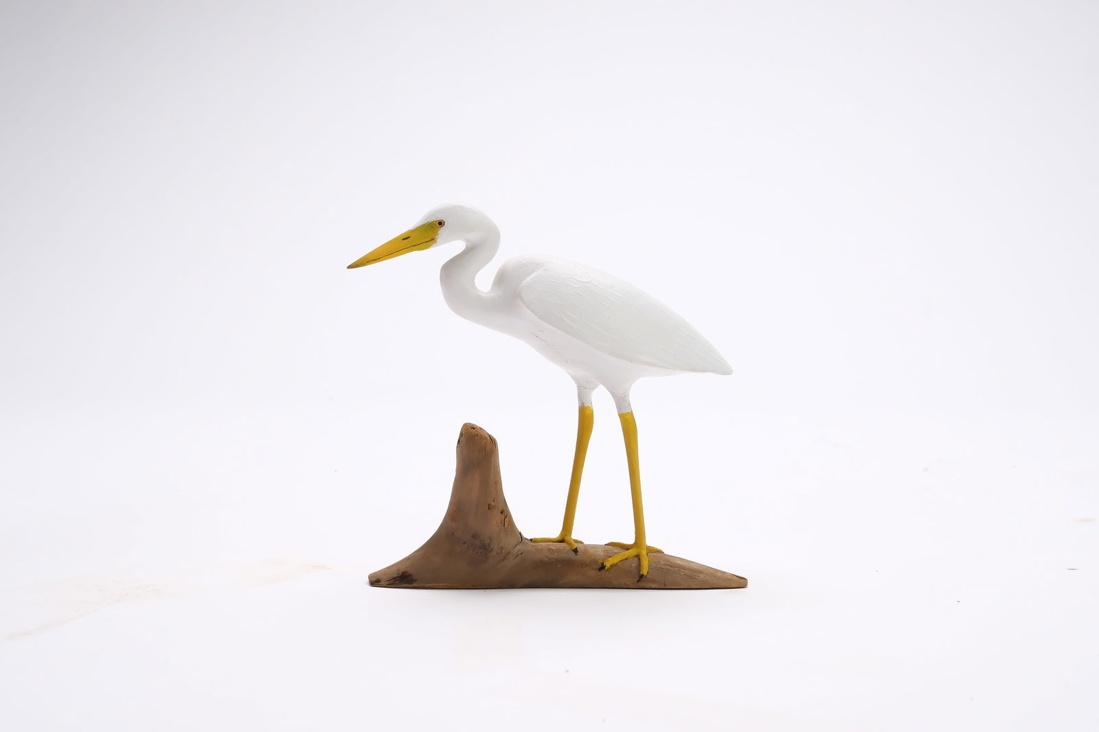 Harold Gibbs (1886-1970), Barrington, Rhode Island.: Miniature great white heron. Deep relief wing carving. Identified, signed, and dated 1964. Measures 4.25" long. Provenance: Joseph Ellis collection.