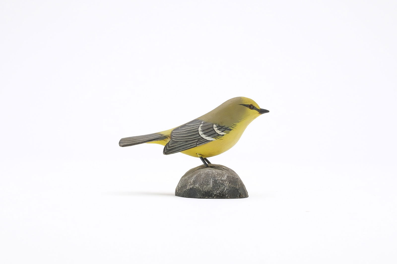 Jess Blackstone (1909-1988), Concord, New Hampshire.: Miniature blue winged warbler. Dropped wing carving and feather rasping. Identified, initialed, and numbered 1 on underside. Measures 3.5" long. Provenance: Joseph Ellis collection.