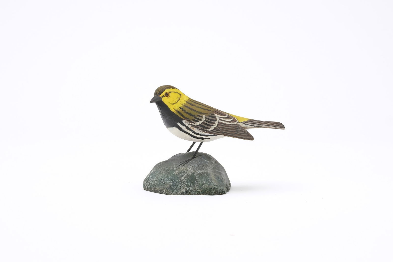 Jess Blackstone (1909-1988), Concord, New Hampshire.: Miniature black throated green warbler. Dropped wing carving and feather rasping. Rare slightly turned head. Identified, initialed, and numbered 45 on underside. Measures 3.5" long. Provenance: J