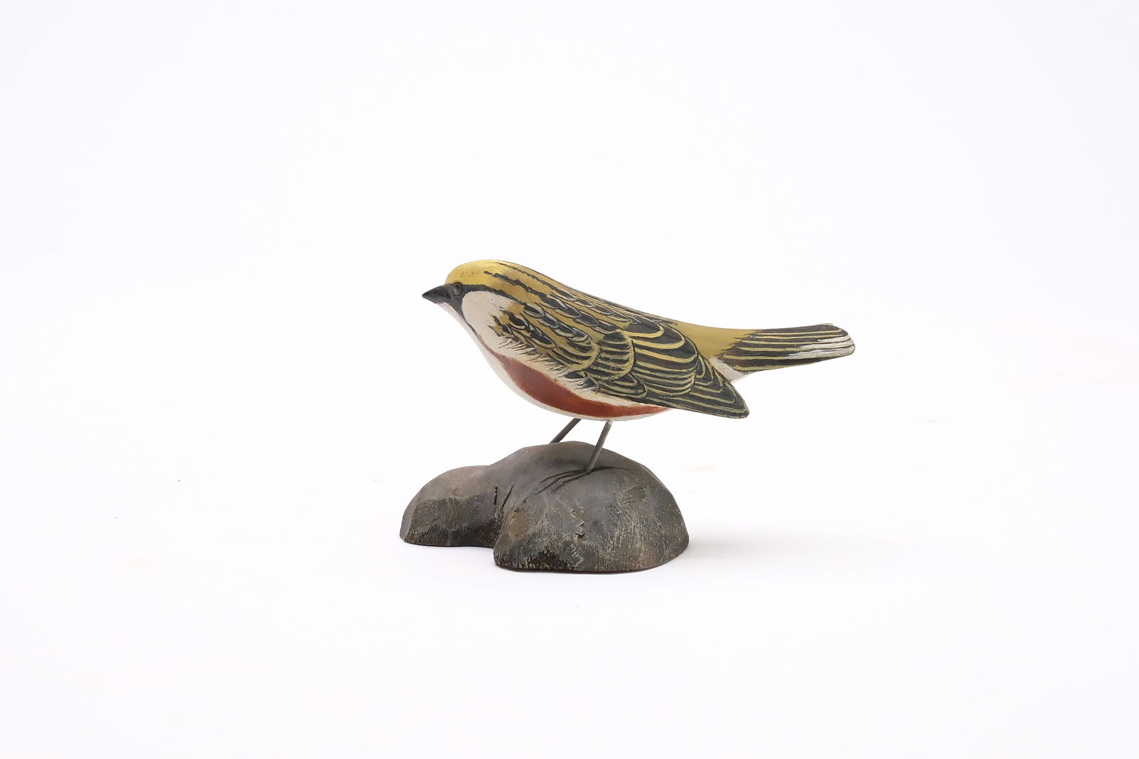 Jess Blackstone (1909-1988), Concord, New Hampshire.: Miniature chestnut sided warbler. Dropped wing carving and feather rasping. Head is turned slightly to one side. Identified and numbered 31 on underside. Measures 3.5" long. Provenance: Joseph El