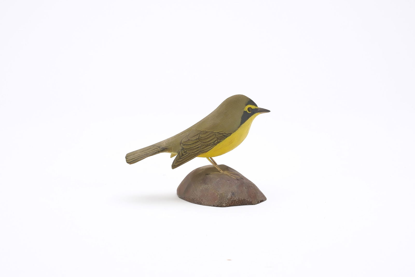 Jess Blackstone (1909-1988), Concord, New Hampshire.: Miniature kentucky warbler. Dropped wing carving and feather rasping. Identified and numbered 2 on underside. Measures 3.75" long. Provenance: Joseph Ellis collection.