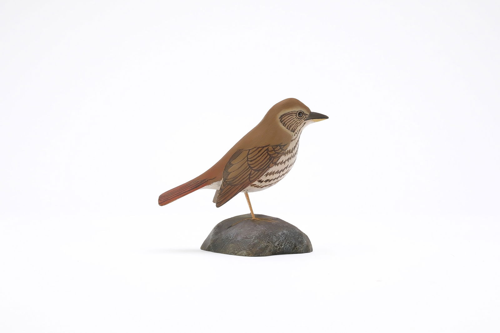 Jess Blackstone (1909-1988), Concord, New Hampshire.: Miniature hermit thrush. Dropped wing carving and feather rasping. Identified, initialed, and numbered 12 on underside. Measures 4" long. Provenance: Joseph Ellis collection.