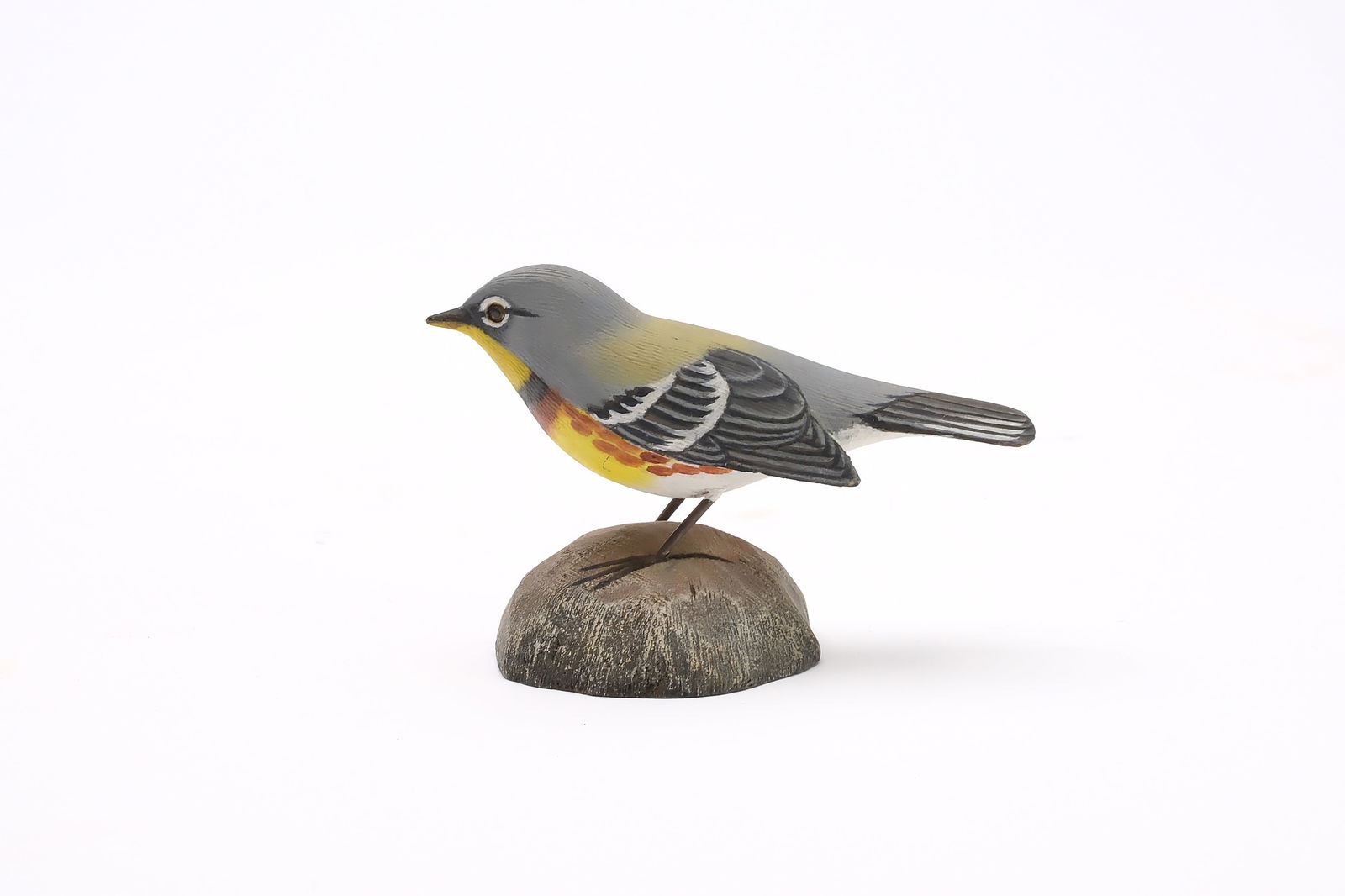 Jess Blackstone (1909-1988), Concord, New Hampshire.: Miniature Parula warbler. Dropped wing carving and feather rasping. Identified, initialed, and numbered 8 on underside. Measures 3.5" long. Provenance: Joseph Ellis collection.