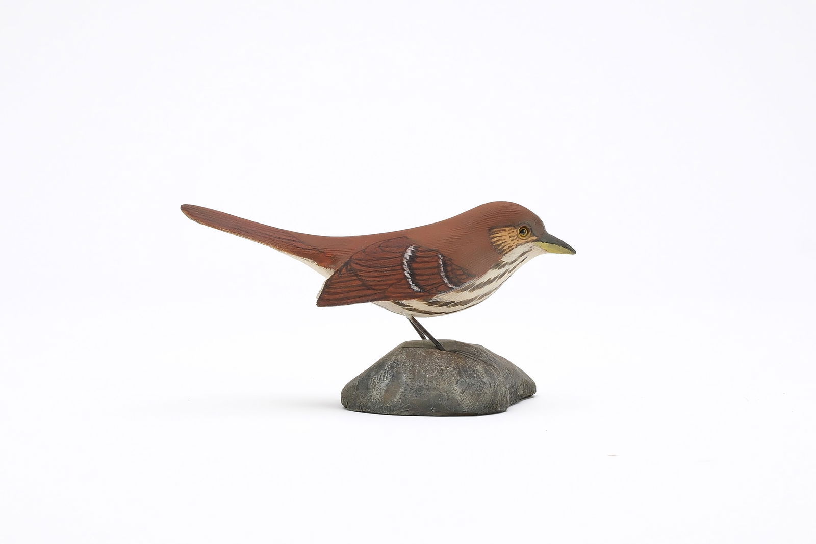 Jess Blackstone (1909-1988), Concord, New Hampshire.: Miniautre thrasher. Dropped wing carving and feather rasping. Identified, initialed, and numbered 31 on underside. Measures 4.25" long. Provenance: Joseph Ellis collection. Literature: "Birds in