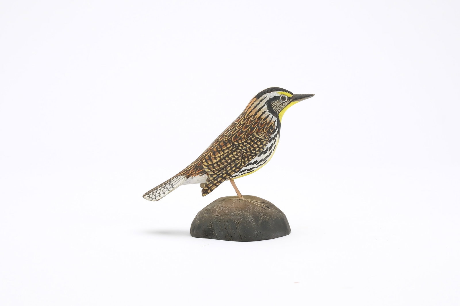 Jess Blackstone (1909-1988), Concord, New Hampshire.: Miniature meadowlark. Dropped wing carving and feather rasping. Identified, initialed, and numbered 88 on underside. Measures 4.25" long. Provenance: Joseph Ellis collection.