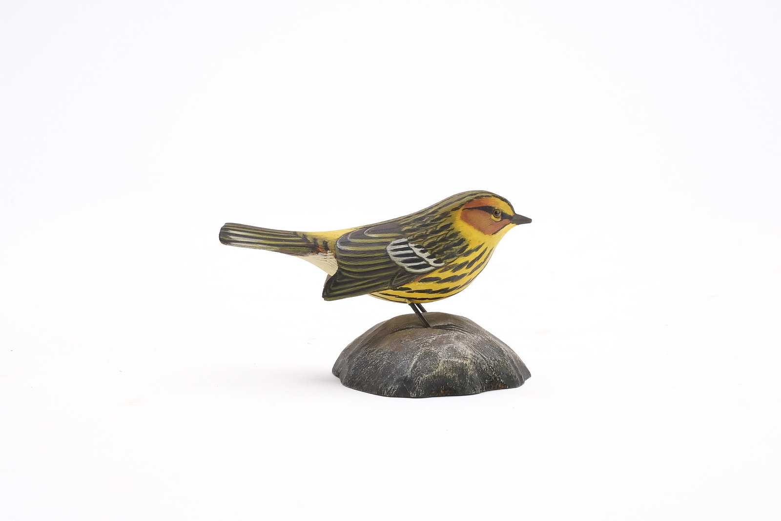 Jess Blackstone (1909-1988), Concord, New Hampshire.: Miniature Cape May warbler. Dropped wing carving and feather rasping. Identified, initialed, and numbered 6522 on underside. Measures 3.5" long. Provenance: Joseph Ellis collection.
