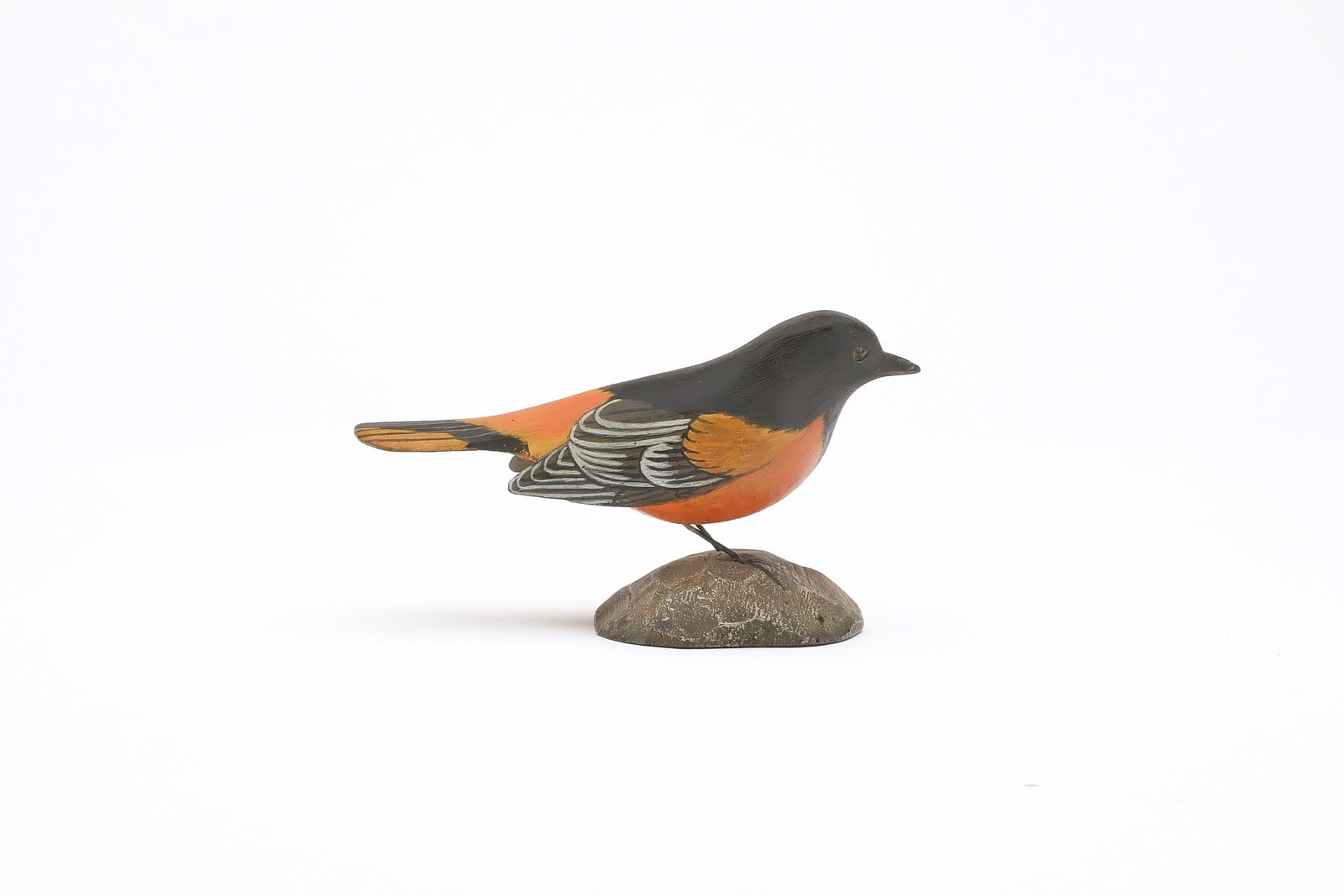 Jess Blackstone (1909-1988), Concord, New Hampshire.: Miniature Baltimore oriole. Dropped wing carving and feather rasping. Identified, initialed, and numbered 3 on underside. Also dated 1951. Measures 4.25" long. Provenance: Joseph Ellis collection
