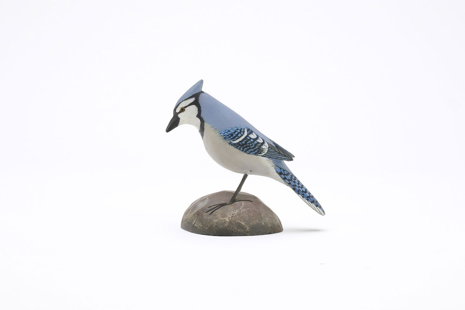 Jess Blackstone (1909-1988), Concord, New Hampshire.: Miniature blue jay. Raised wingtips and feather rasping. Slightly turned head with extended crest. Identified, initialed, and numbered 76 on underside. Measures 4" long. Provenance: Joseph Ellis