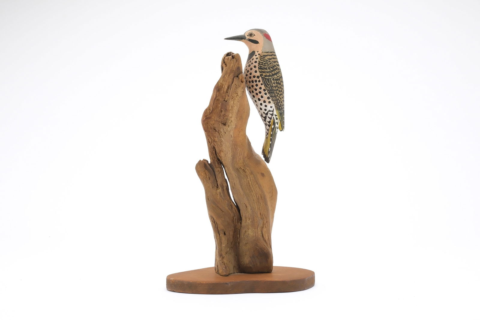 Jess Blackstone (1909-1988), Concord, New Hampshire.: Miniature flicker on natural wood base. Raised wingtips and feather rasping. Relief tail feather carving. Identified, initialed, and numbered 3 on underside. Flicker Measures 4.25" long, stands 8