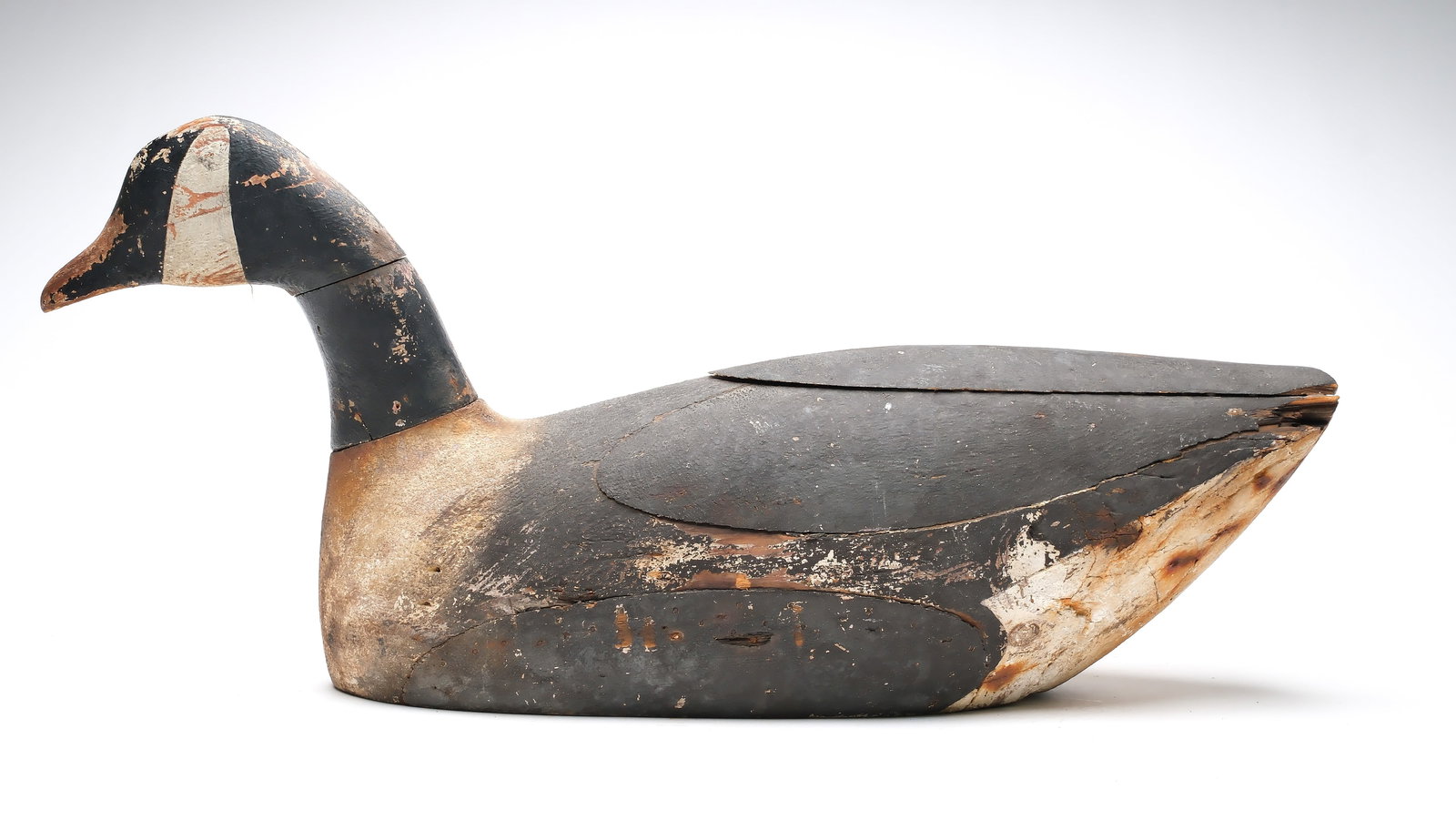 Charles Safford (1877-1957), Newburyport, Massachusetts.: Large swimming Canada goose. Typical scab wood construction. Using multiple pieces of wood. "H. Day" branded twice on underside. Measures 31" long. Provenance: Dan Graf collection.