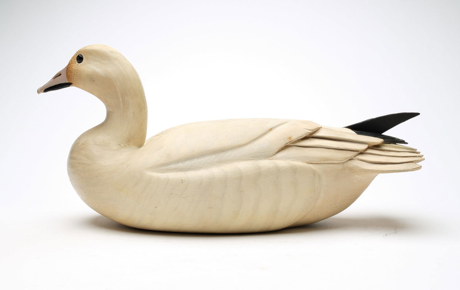 Ward Brothers, Crisfield, Maryland.: Decorative snow goose. Hollow carved with slightly turned head and deep relief wing carving. Extended, crossed wingtips. Signed and dated 1967 on underside. Measures 19.75" long. Provenance: Don Leona