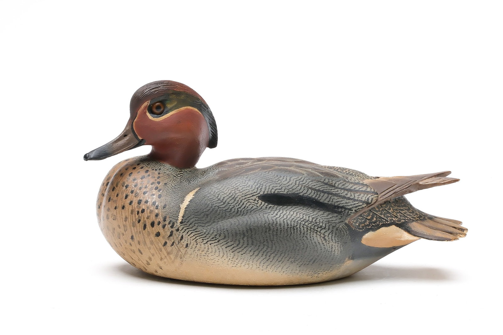 Ward Brothers, Crisfield, Maryland.: Decorative greenwing teal. Hollow carved with relief wing carving and extended crossed wingtips. Head is slightly turned with extended crest. Signed and dated 1967 on underside. Measures 10.5" long. P
