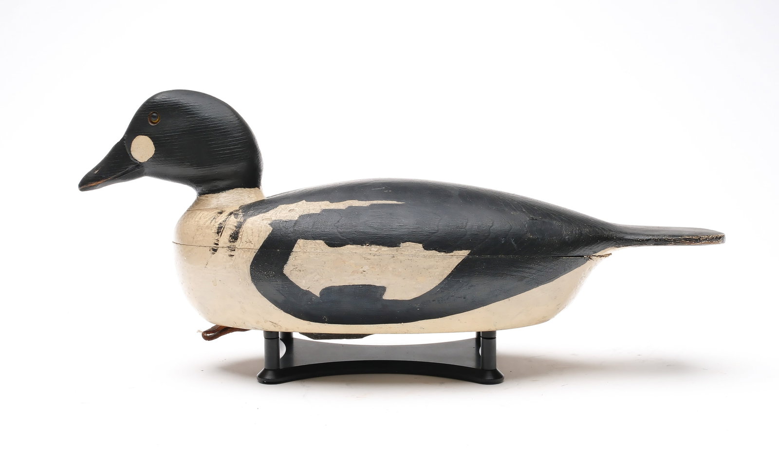 Clark Madera (1883-1953), Pitman, New Jersey.: Goldeneye. Hollow carved with painted tack eyes and wide paddle tail. Measures 16" long.