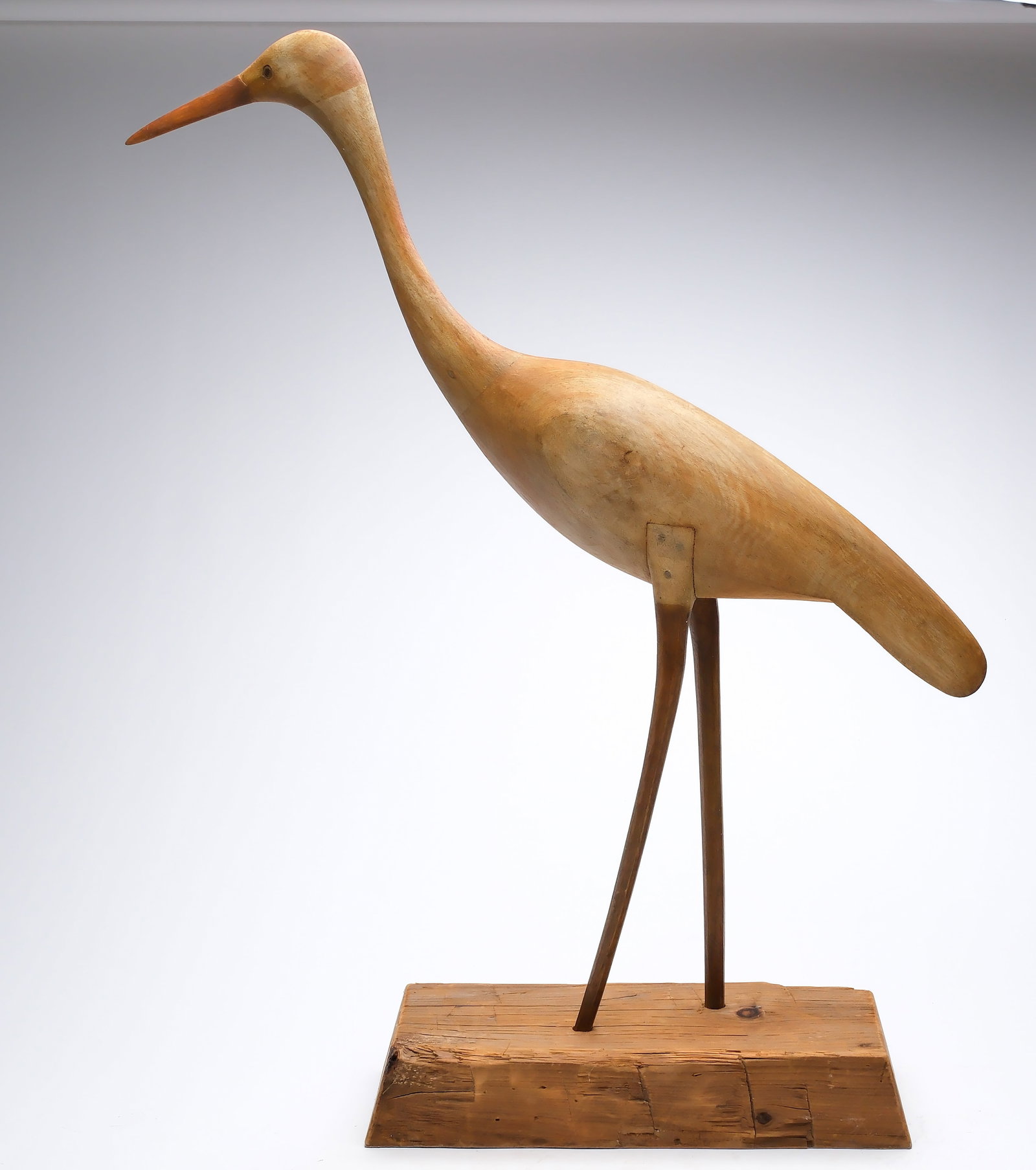 Mark McNair (b.1950), Craddockville, Virginia.: White heron. Wooden legs are inlaid in to body with wooden pegs. "McNair" carved in underside. Measures 32.5" long, stands 35.5" tall with included base. 