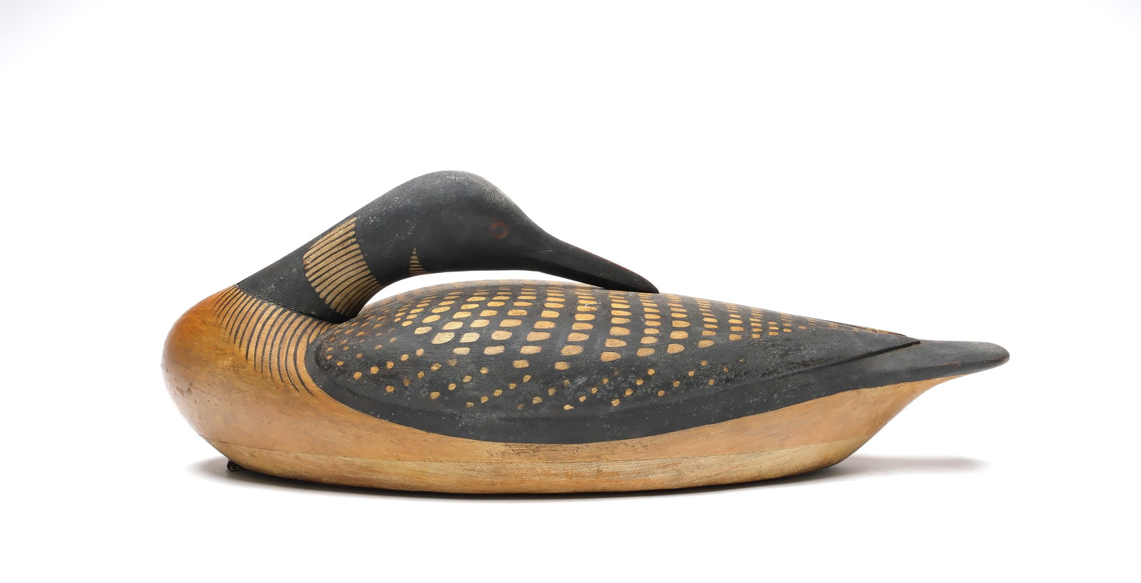 Mark McNair (b.1950), Craddockville, Virginia.: Very rare preening loon. Hollow carved with relief wing carving and carved eyes. "McNair" carved in underside. Measures 22.25" long. 