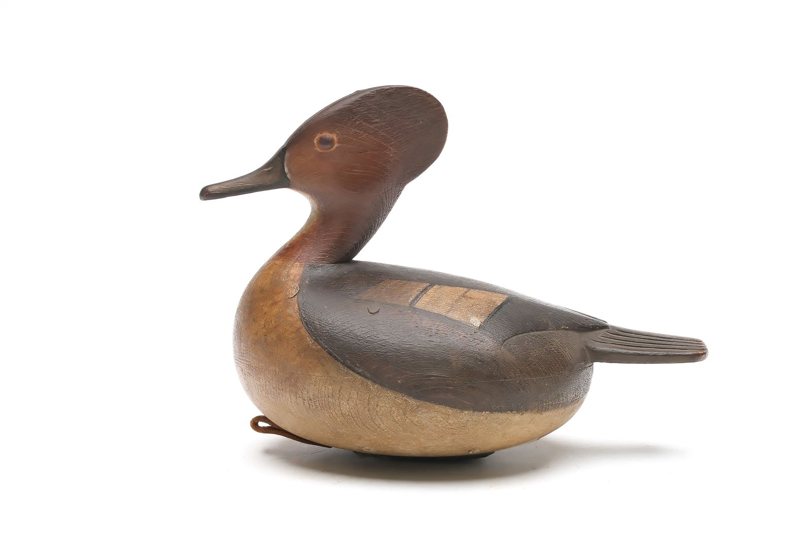 Mark McNair (b.1950), Craddockville, Virginia.: Hooded merganser hen. Hollow carved with small wooden pegs attaching body halves. Relief wingtip and tail feather carving. Reared back head with extended crest. "McNair" carved in underside. Measures
