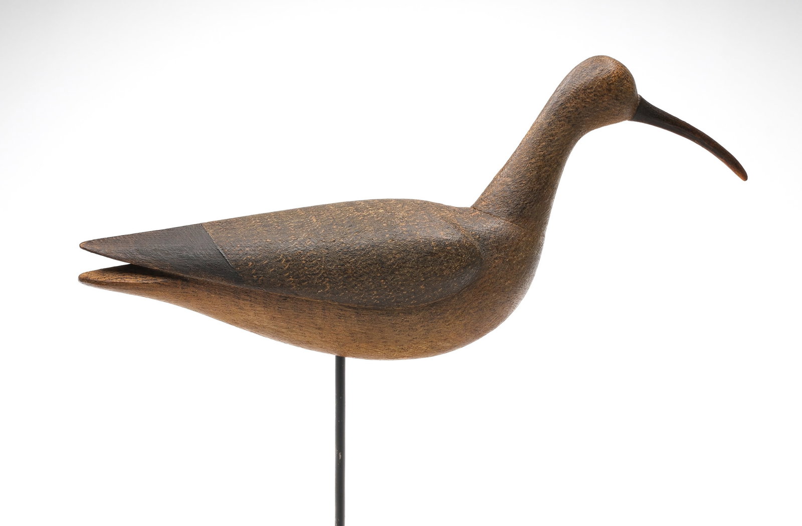 Mark McNair (b.1950), Craddockville, Virginia.: Curlew. Deep relief wing carving and slightly turned head. "McNair" carved in underside. Measures 15" long .
