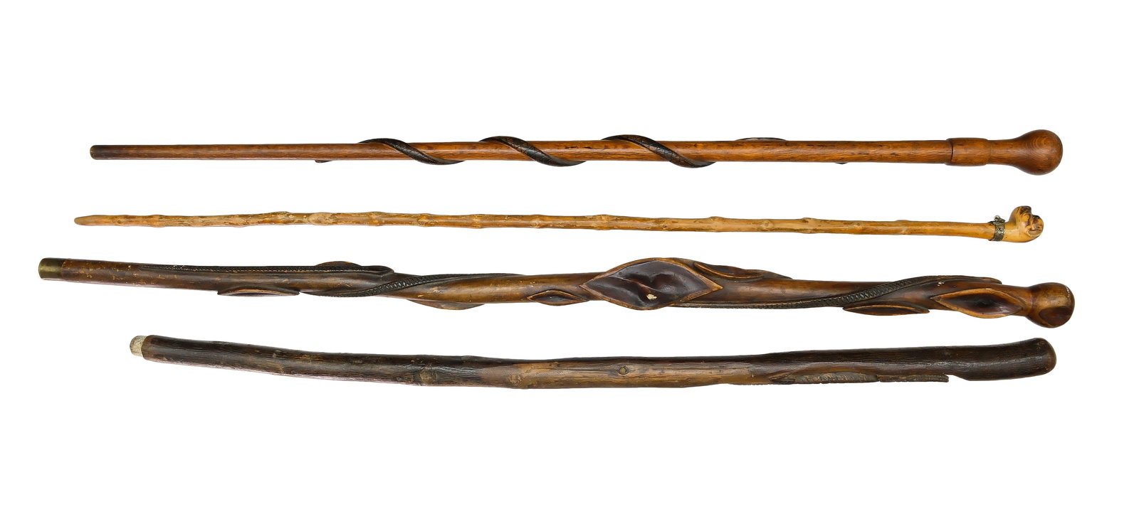 Four antique walking sticks.: One stick has a painted snake with red bead eyes. One willow stick with carved and painted snake. One with an alligator similar to sticks found in Florida. One that may be English has a bull dog head