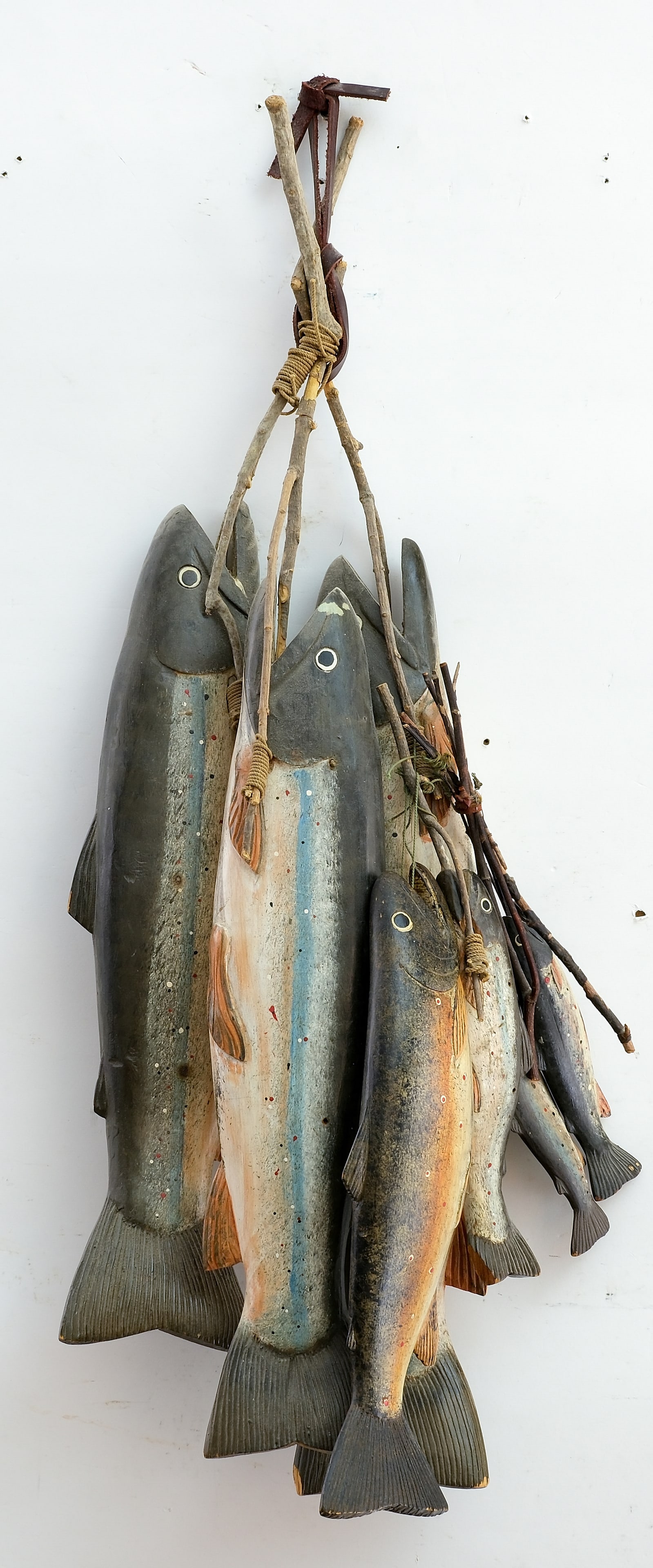 A group of seven carved and painted trout from Quebec, circa 1950.: Longest fish measures 18". All are in very good condition; small tip of fin missing from one of the large fish. 
