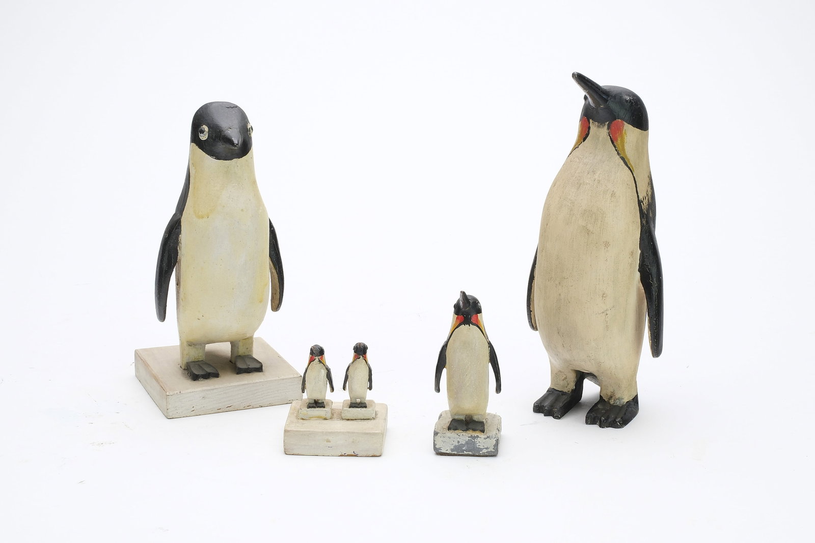 Charles Hart (1862-1960), Gloucester, Massachusetts.: Group of penguins. Largest is a very rare hollow cast metal with excellent patina. Other penguins are carved wood, with one having a lead base. Smallest carved double mount measures only 2" tall,