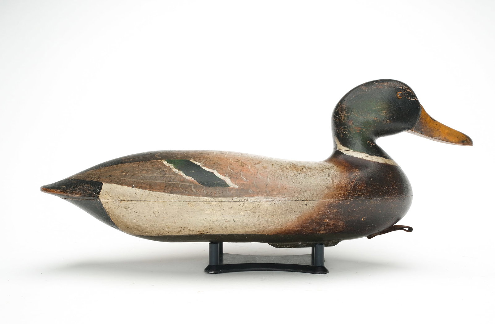 John Blair, Sr. (1843-1929), Philadelphia, Pennsylvania.: Rare mallard. Hollow carved with tack eyes and raised neck seat. “C. Sprickles” branded on the underside. Measures 17” long. Original paint with minor flaking and wear, mostly on hea