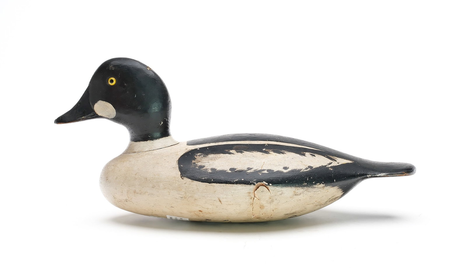 Harvey Stevens (1847-1894), Weedsport, New York.: Important goldeneye. Maker’s paint stencil on underside. Also identified in pencil. “S” branded near inlaid lead weight that is stamped “W.J.S.”. Measures 14.25” lo