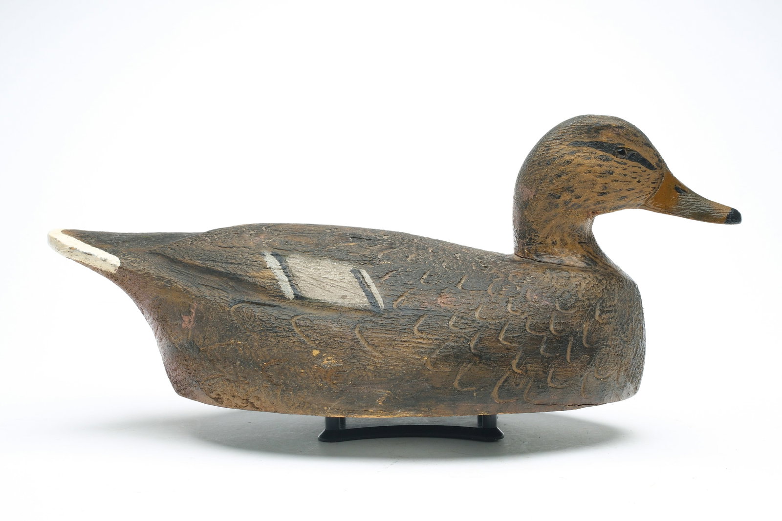 Frank Schmidt (1879 - 1960), Detroit, Michigan.: Large mallard hen. Slight relief wing carving. Measures 18” long. Provenance: Jim and Diane Cook collection.