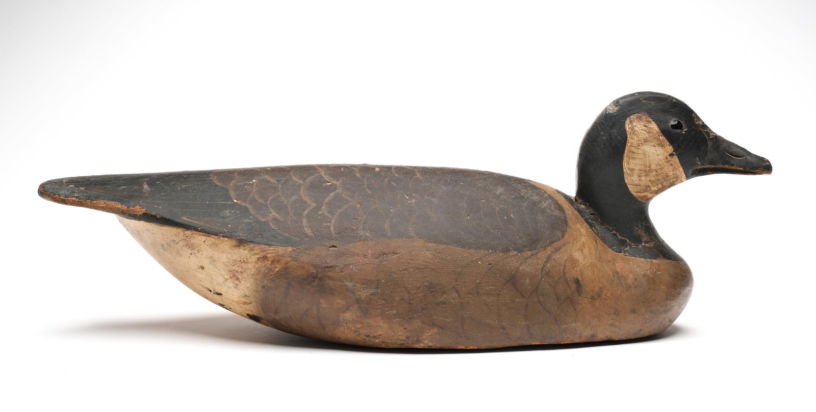 Ward Brothers, Crisfield, Maryland.: Circa 1930. Canada goose. With a rare tucked head position. Glass eyes. Slightly turned head. Feahter painting on body. Signed on underside. Measures 24" long. Provenance: Oliver Smith collection.