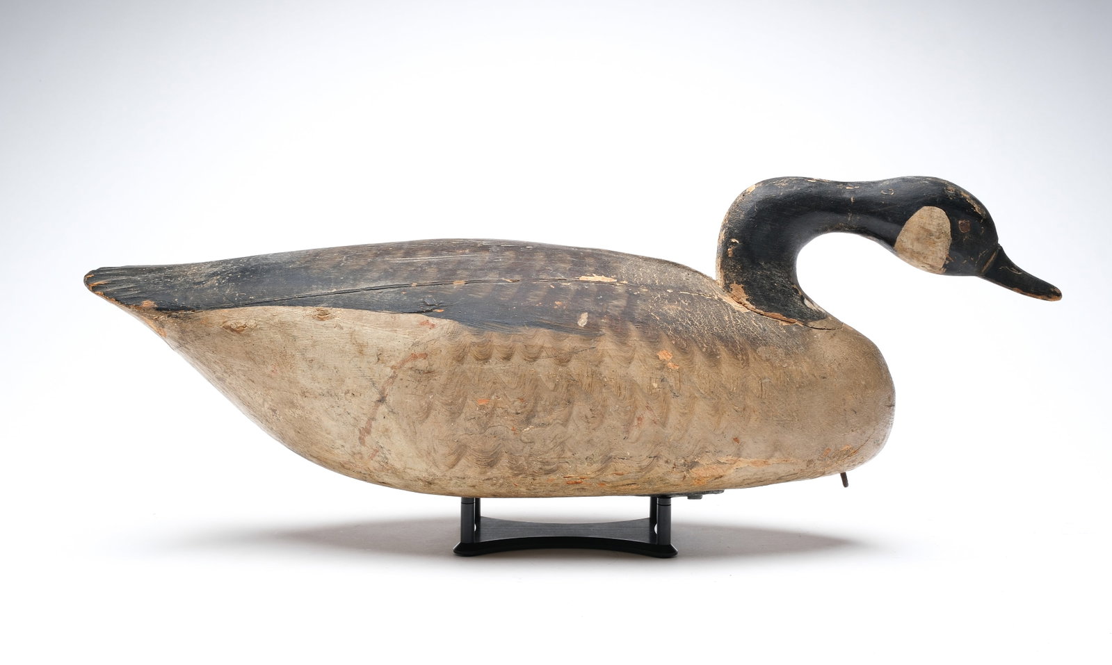 Ira Hudson (1873-1949), Chincoteague, Virginia.: Swimming Canada goose. Fluted tail and ice groove carving. Excellent head carving and tack eyes. Measures 26.5" long. Provenance: Don Leonard collection.