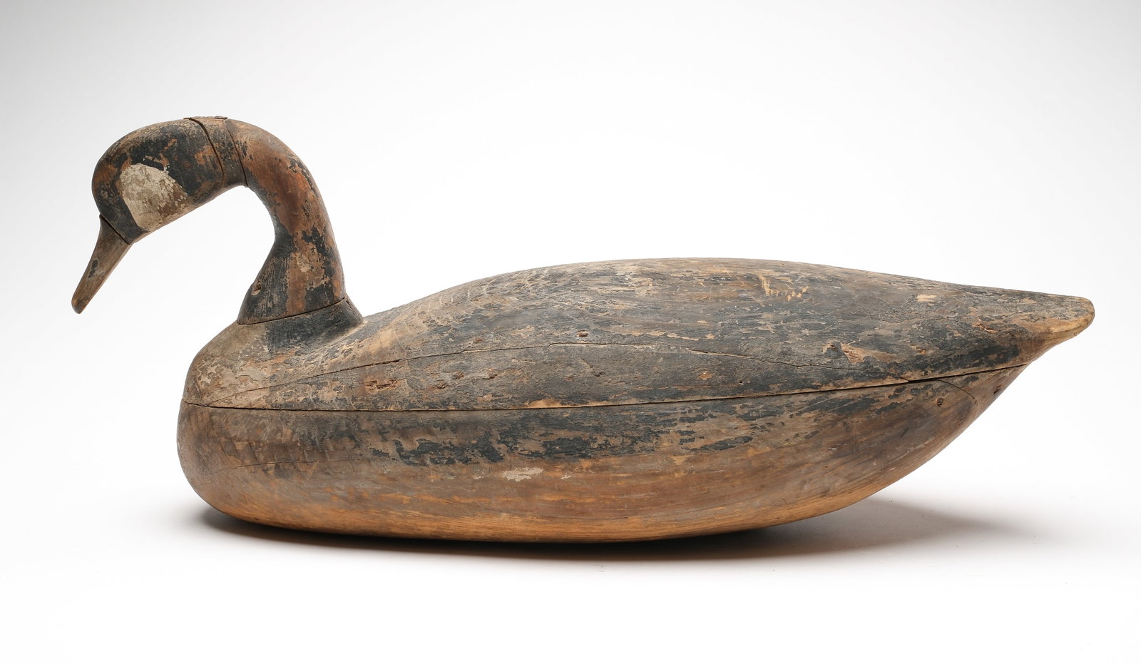 Canada goose, attributed to John Henry Downes.: Hollow carved with raised neck seat and splined hardwood bill. Measures 24" long. Provenance: Oliver Smith collection.