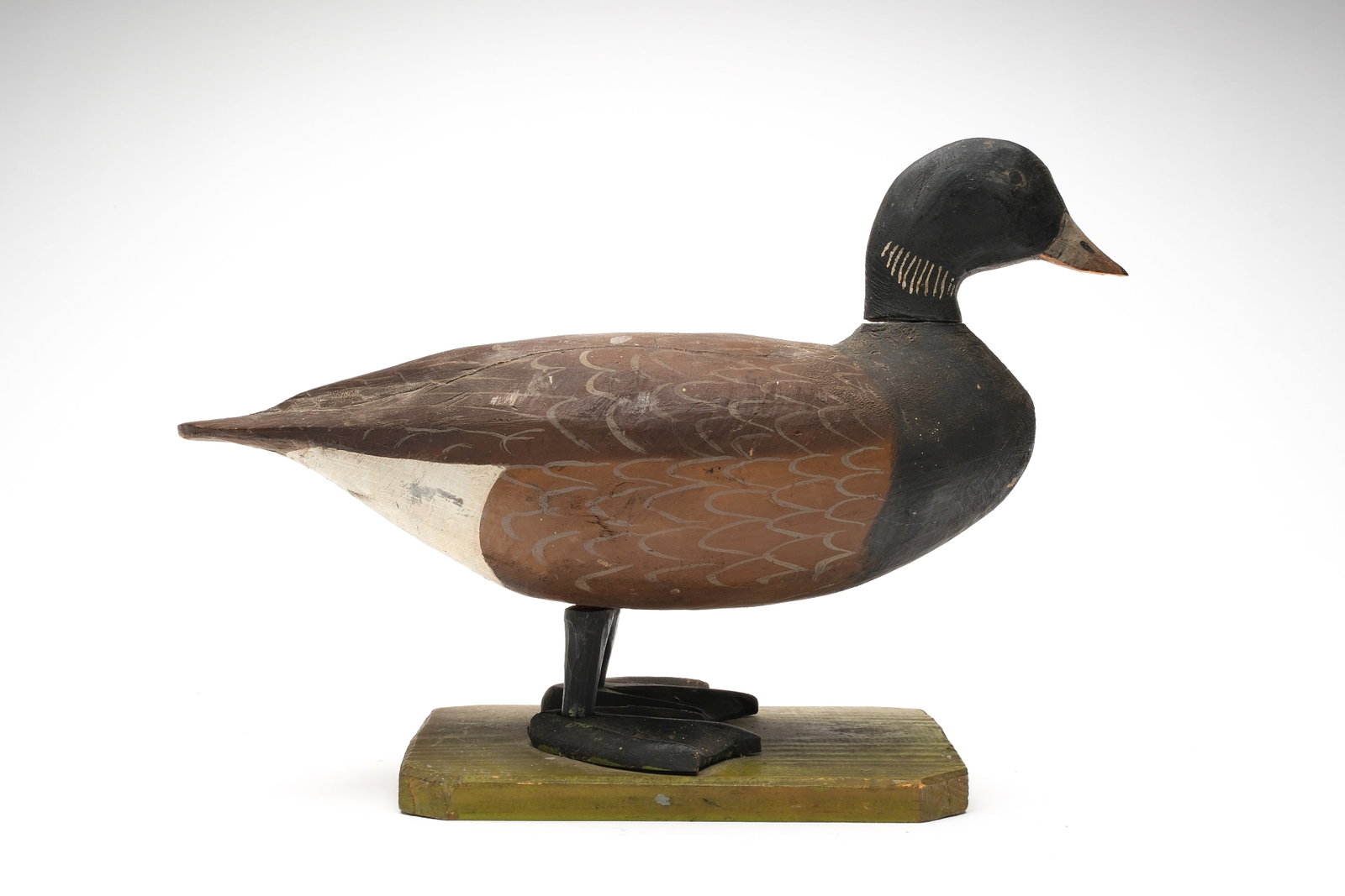Lloyd Tyler (1898-1971), Crisfield, Maryland.: Possibly unique full size standing brant. Carved legs and feet on green painted bottom board. Slight relief wingtip carving. Measures 18" long, stands 12" tall.