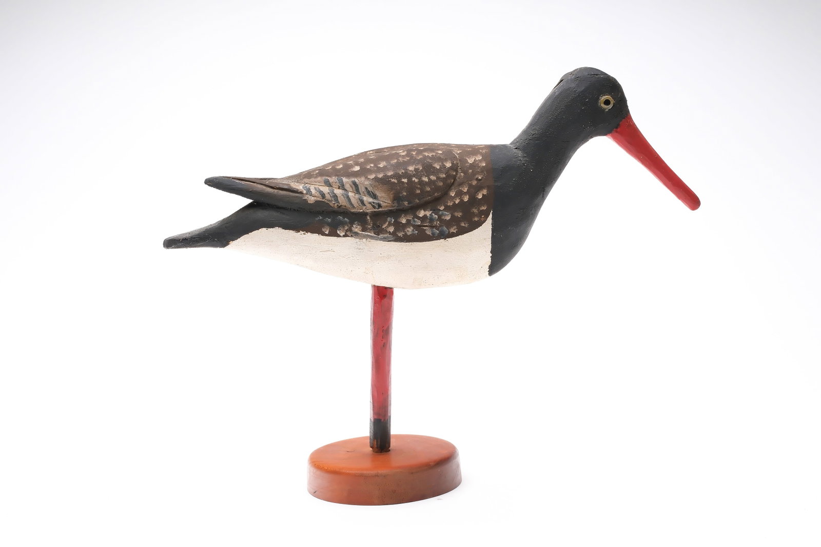 Miles Hancock (1887-1974), Chincoteague, Virginia.: Oyster catcher. Balsa body with relief wing carving and raised wingtips. Original painted oak stake is attached to hardwood base. Signed on the underside. Measures 13" long.