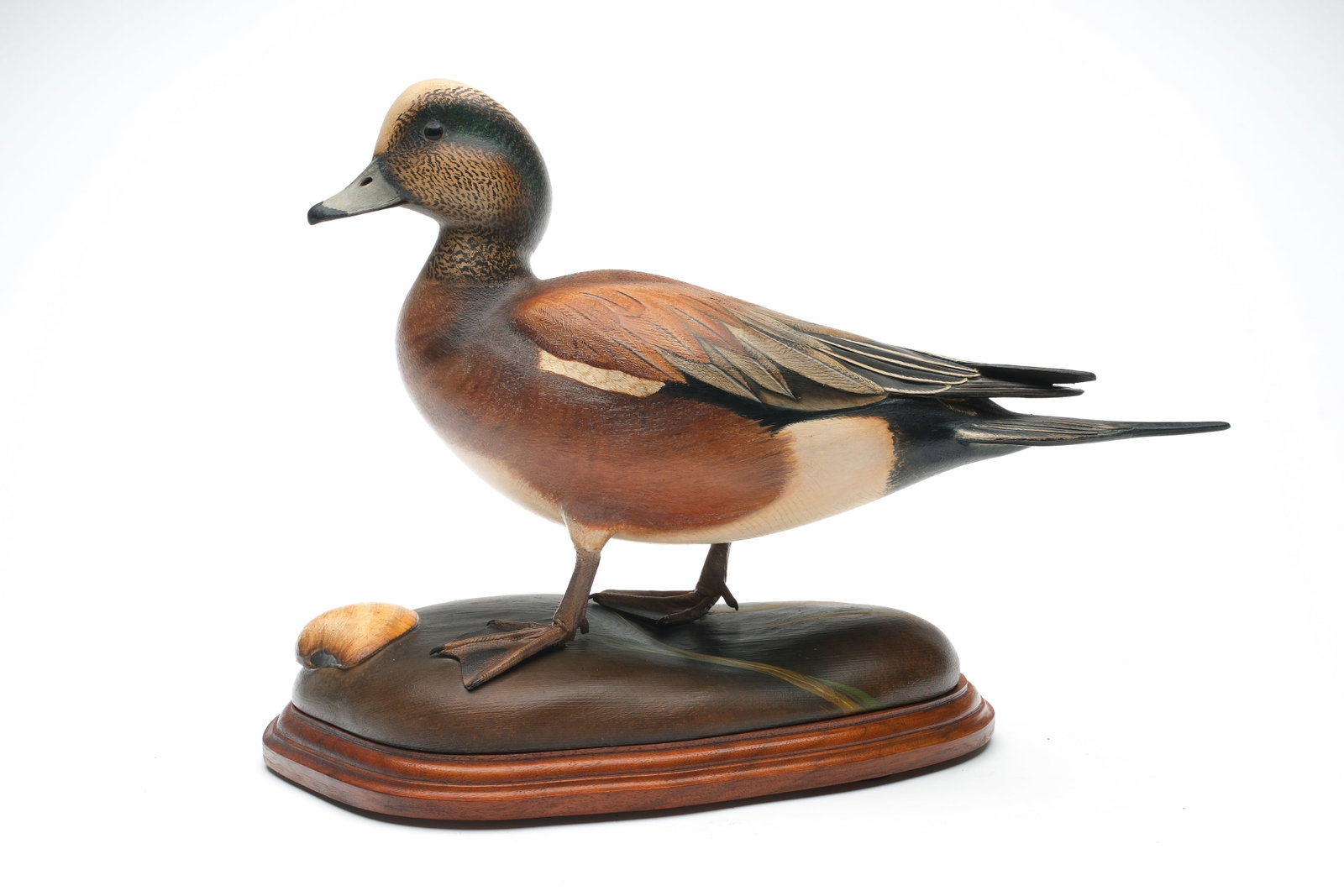 William Gibian (b.1946), Onancock, Virginia.: Beautiful decorative widgeon. Hollow carved with slightly turned head and raised, crossed wingtips. Relief wing and tail feather carving. Comb feather paint detail on back. Maker's business card on un