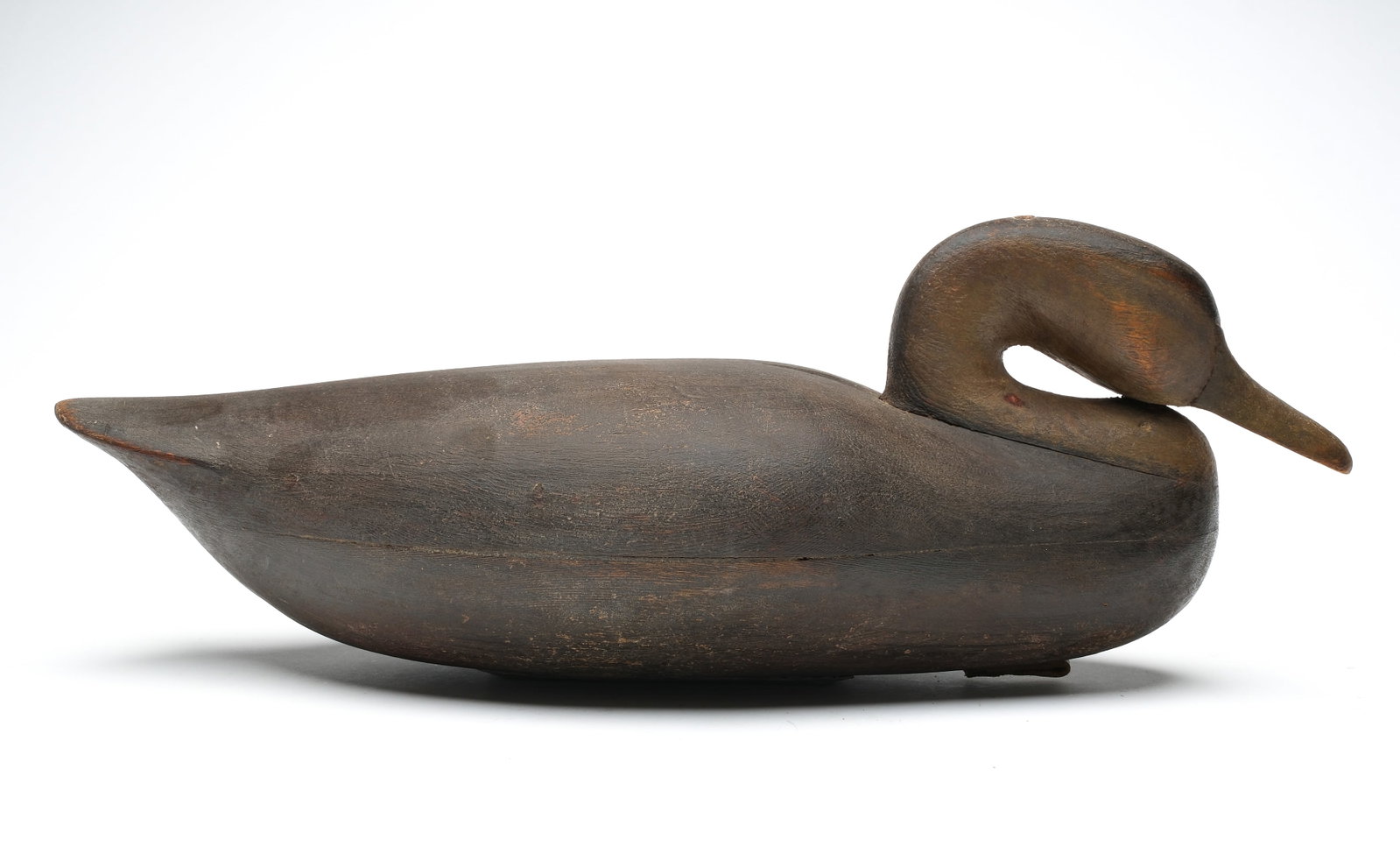 Mark McNair (b.1950), Craddockville, Virginia.: Oversized black duck. Hollow carved with tucked head influenced by the Cobb family. "McNair" carved in underside and "5" carved under tail. Measures 22" long. Provenance: Don Leonard collection.