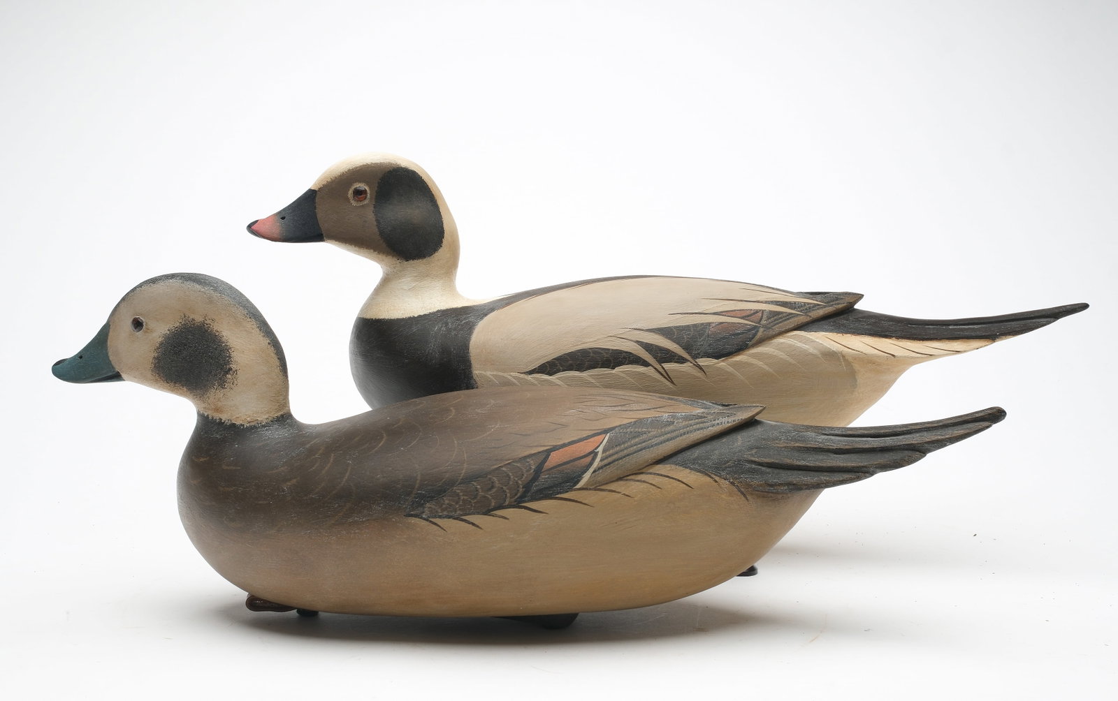 Robert "Bob" White (b. 1939) Tullytown, Pennsylvania.: Pair of hollow carved long-tailed ducks with raised wing tips and glass eyes. Signed and dated 2006. Maker's signature weight on bottom. Drake measures 17.5" long.